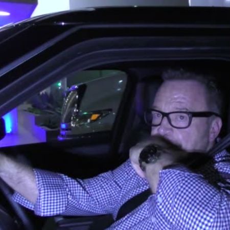 Tom Arnold on his car